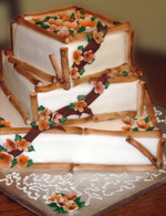 Stacked square rolled fondant wedding cake with hand-made fondant bamboo edging and flowers