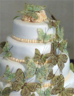 Stacked rolled fondant wedding cake with a butterfly cascade.