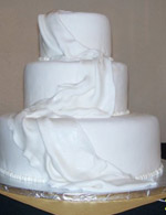 Thinly draped fondant sets the elegance of this cake a part. This cake is as beautiful with or without fresh flowers.