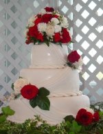 Rolled fondant weddding cake with drapes and roses.