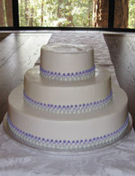 Stacked single layer wedding cake with three-toned purple dots