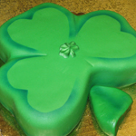 A fondant covered shamrock cake decrated to perfection, a Gristmill custom cake
