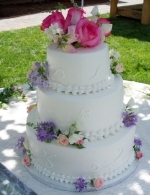 Stacked cake with fresh roses.