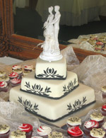 Stenciled rolled fondant wedding cake with matching cupcakes