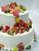 Stacked wedding cake with fall color and acorns.